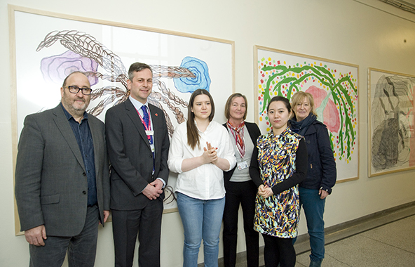 Simon Betts (Dean of Wimbledon College of Arts), Daniel Elkeles (our Chief Executive), Madina Mukhtarova (winner for ‘The Trees’), Pat Baskerville (Chair of Organ Donation Committee), Yige Yang (winner for ‘The Gift’), and Rosie Potter (Senior Lecturer) standing in front of 'The Trees'