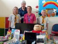 Bob the Bear with local scouts and play specialist, Amanda Laughton.